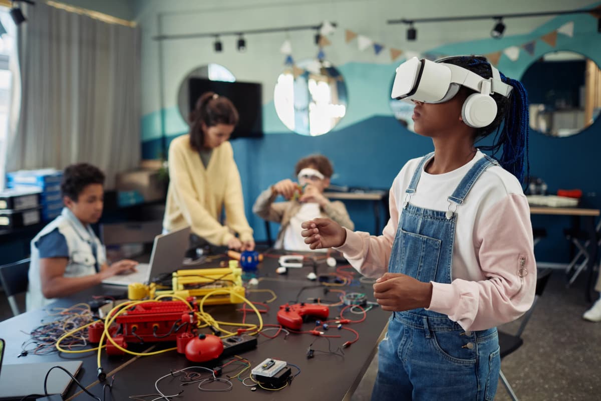 Kids exploring virtual reality and technology workshops at a youth camp