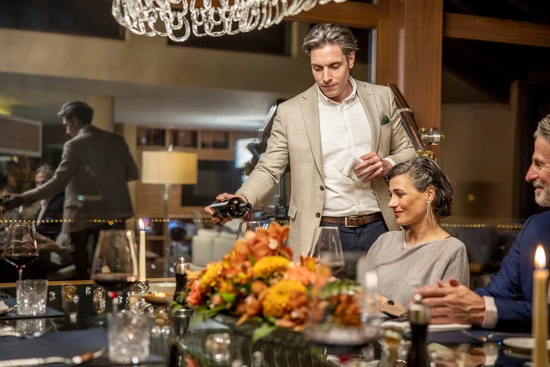A chef presenting a delicious dish, highlighting the quality and presentation of the food provided.